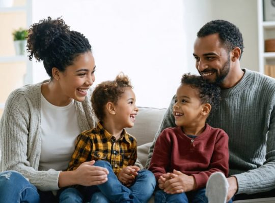 A family of diverse backgrounds engaged in open and positive communication, symbolizing healthy family dynamics and emotional well-being.