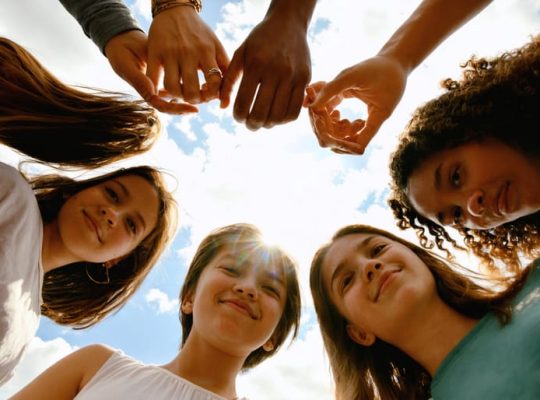 A diverse group of young people forming a supportive circle, symbolizing unity, empathy, and hope in transforming youth mental health through peer support.