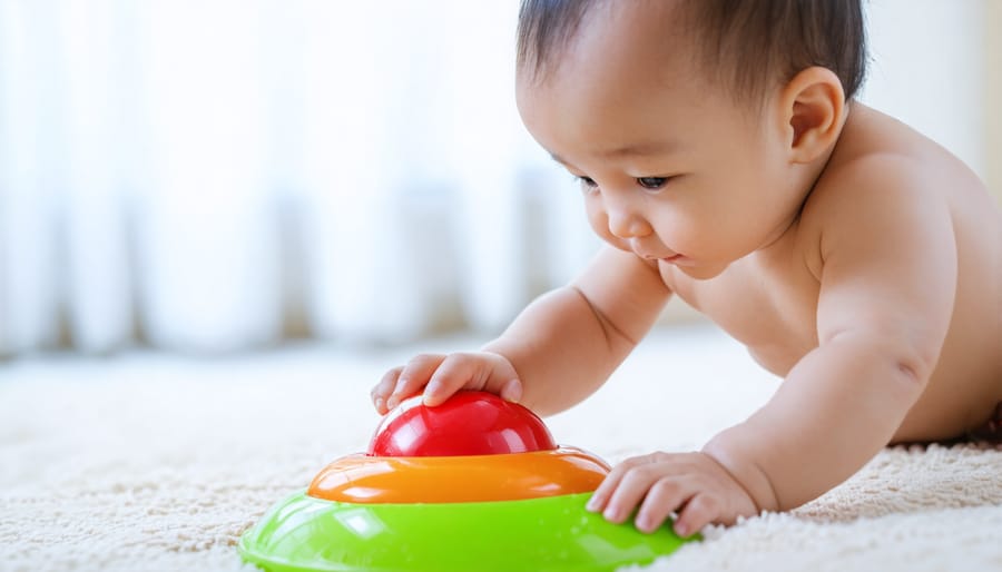 Baby reaching for a visually stimulating toy with bright colors and high contrast