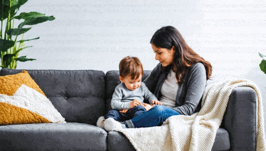 A caring parent comforts their anxious child in a nurturing home environment, surrounded by comforting elements like a soft blanket and warm lighting, symbolizing a supportive atmosphere.