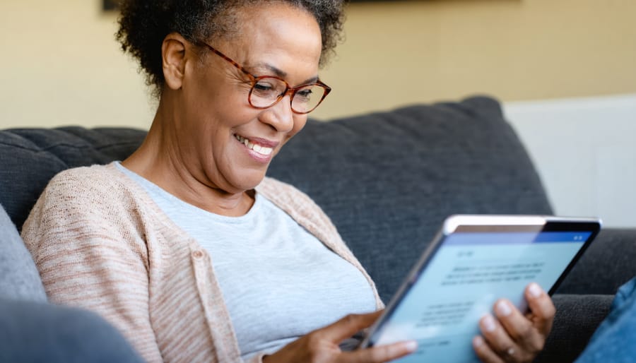 Parent engaging with an online mental health support community on their tablet