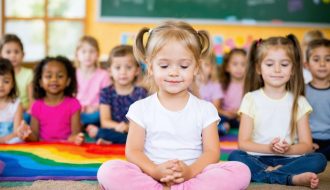 A diverse group of children practicing various mindfulness exercises in a classroom, including deep breathing, sensory awareness, and gentle movements, all promoting a calm and focused environment.